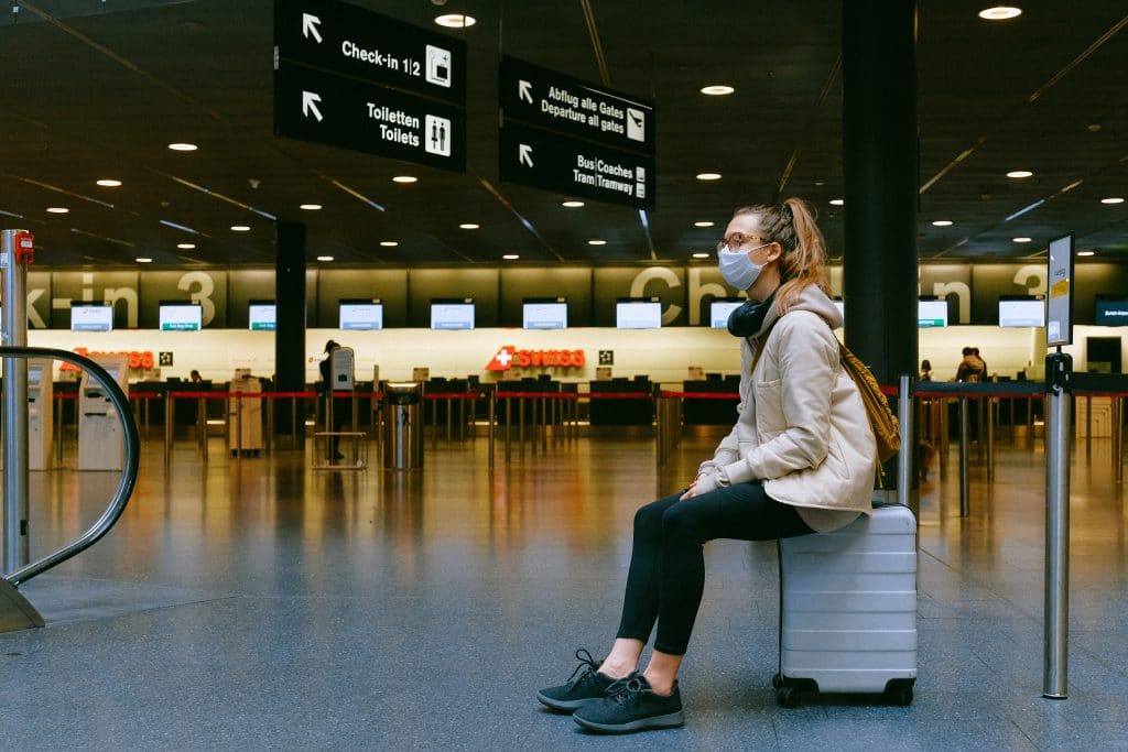 Lady sat in airport lounge news of border restrictions