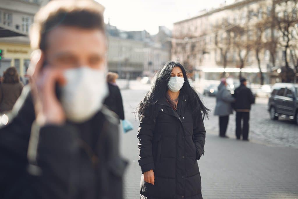 covid travel advisory discourages American tourists picture wearing masks