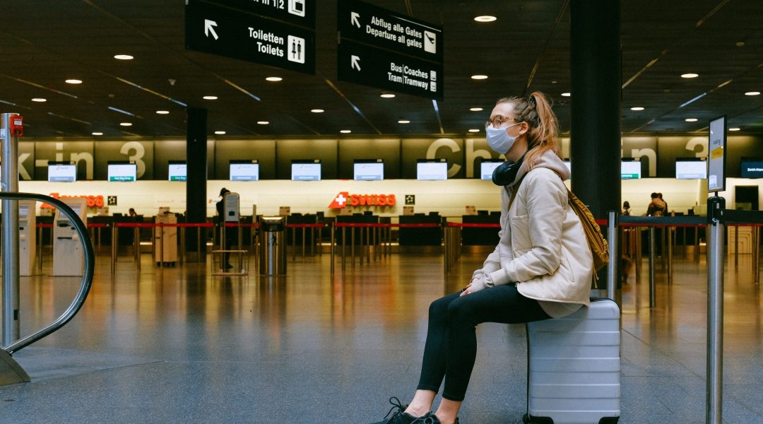 Lady sat in airport lounge news of border restrictions